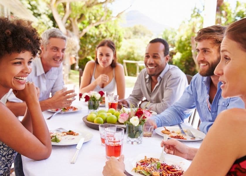 group of friends eating at a restaurant with outside seating group of friends eating at a restaurant with outside seating
