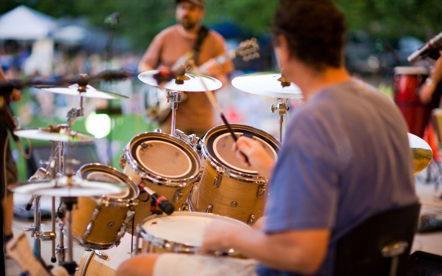 drummer playing in band at a live outdoor concert