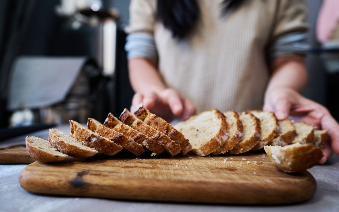 sliced artisan bread spread on a cutting board